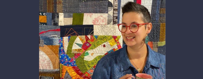 maday delgado in front of one of her scrap quilts