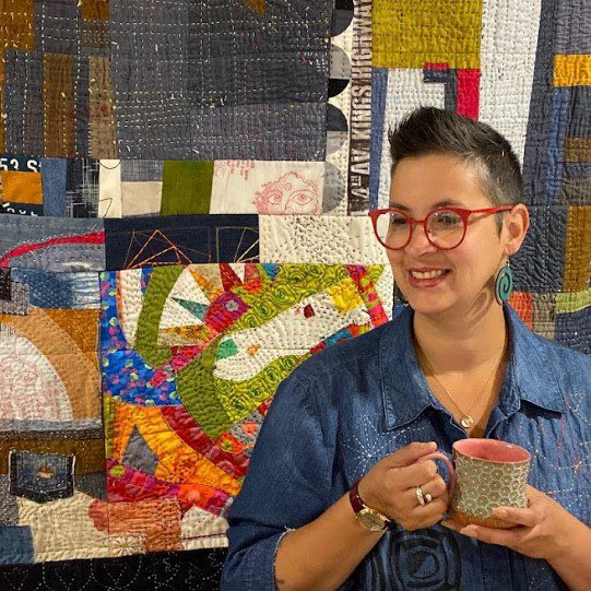 maday delgado in front of a quilt